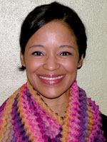 Rachel Griffin headshot - rachel is wearing a pink and purple scarf and there is a plain white backdrop